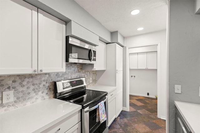 8101 Amelia Rd Unit 509, Houston, TX 77055 - kitchen with stainless steel appliances, tasteful backsplash, dark stone finish floors, light countertops, and recessed lighting