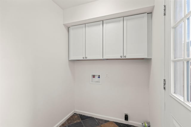 8101 Amelia Rd Unit 509, Houston, TX 77055 - laundry area with washer hookup, cabinet space, and dark stone finish flooring