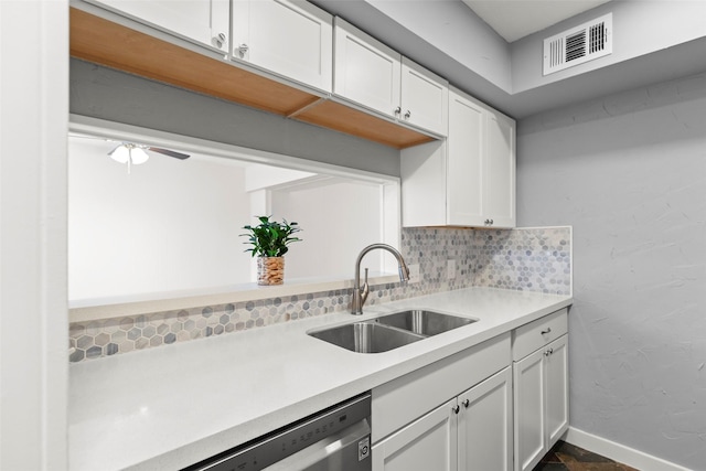 8101 Amelia Rd Unit 509, Houston, TX 77055 - kitchen with light countertops, white cabinetry, tasteful backsplash, and stainless steel dishwasher