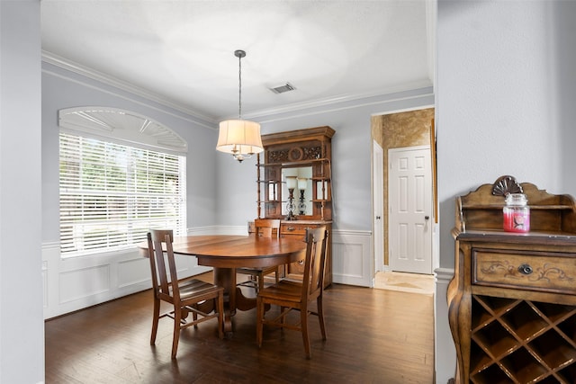 8511 Parmer Ct, Houston, TX 77064 - dining area with crown molding, dark wood finished floors, wainscoting, and a decorative wall