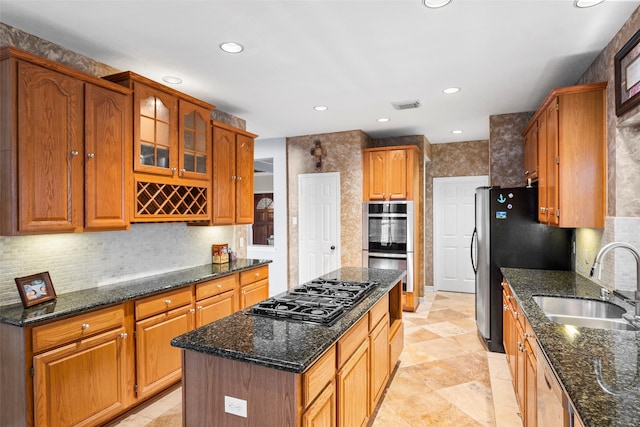 8511 Parmer Ct, Houston, TX 77064 - kitchen with stainless steel appliances, a kitchen island, recessed lighting, dark stone countertops, and tasteful backsplash
