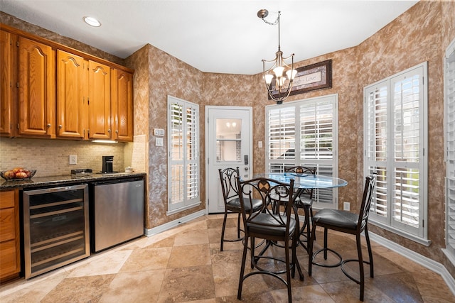 8511 Parmer Ct, Houston, TX 77064 - dining area featuring beverage cooler, healthy amount of natural light, a chandelier, recessed lighting, and light stone finish floors