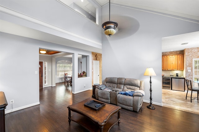 8511 Parmer Ct, Houston, TX 77064 - living area with wood finished floors, wine cooler, a ceiling fan, and a towering ceiling