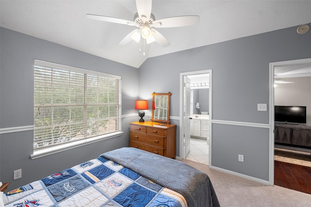 8511 Parmer Ct, Houston, TX 77064 - bedroom with lofted ceiling, a ceiling fan, connected bathroom, and light carpet