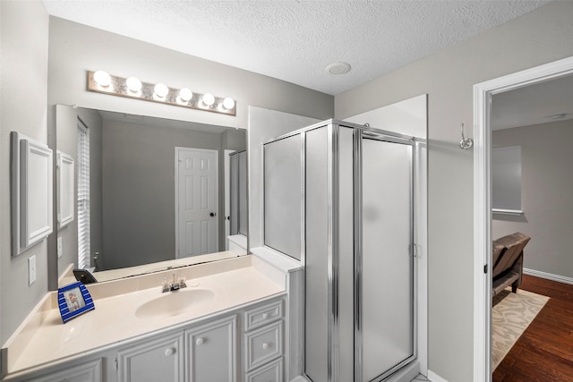 8511 Parmer Ct, Houston, TX 77064 - full bath with a shower stall, vanity, wood finished floors, and a textured ceiling