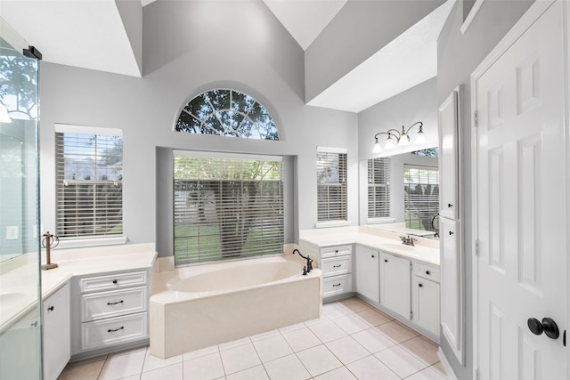 8511 Parmer Ct, Houston, TX 77064 - full bathroom with two vanities, a bath, tile patterned flooring, healthy amount of natural light, and high vaulted ceiling