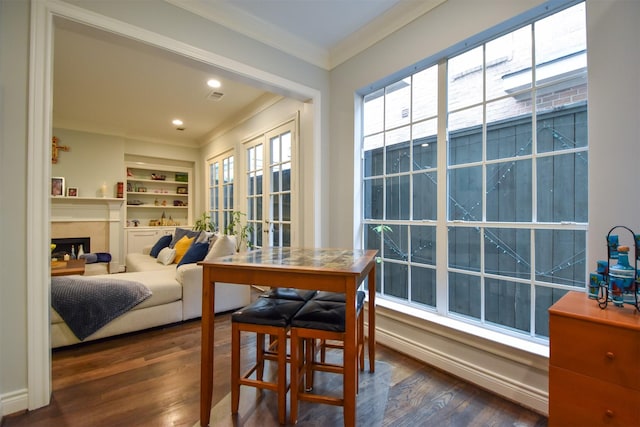 3226 Pemberton Circle Dr, Houston, TX 77025 - dining area with ornamental molding, dark wood finished floors, a fireplace, and built in shelves