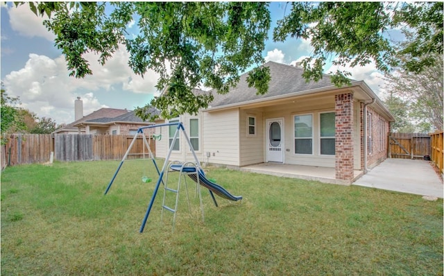 17603 Memorial Falls Dr, Tomball, TX 77375 - back of house featuring a playground, a fenced backyard, a patio, and roof with shingles