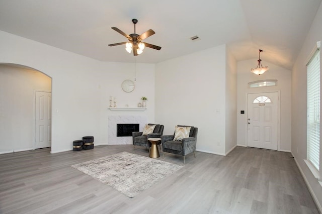 17603 Memorial Falls Dr, Tomball, TX 77375 - foyer with arched walkways, wood finished floors, lofted ceiling, plenty of natural light, and a fireplace