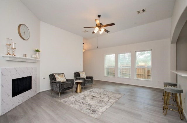 17603 Memorial Falls Dr, Tomball, TX 77375 - sitting room with a ceiling fan, wood finished floors, and a high end fireplace