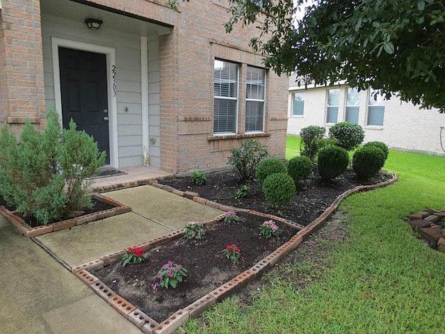 22303 Bridgestone Ridge Dr, Spring, TX 77388 - view of exterior entry with a yard and brick siding