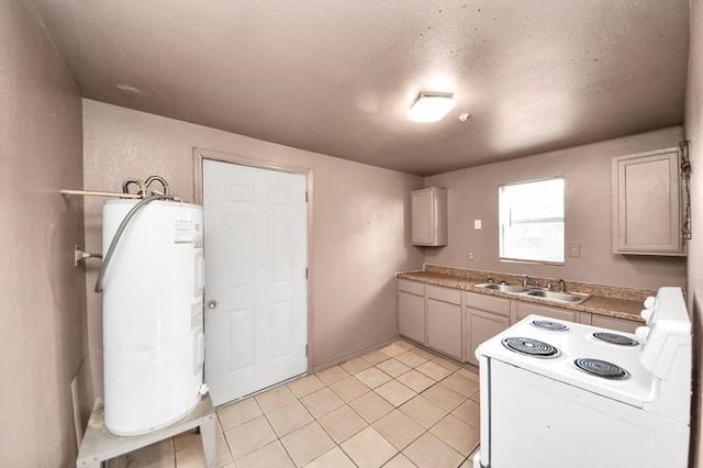 6821 Haight St, Houston, TX 77028 - kitchen with white electric range, electric water heater, and light tile patterned floors