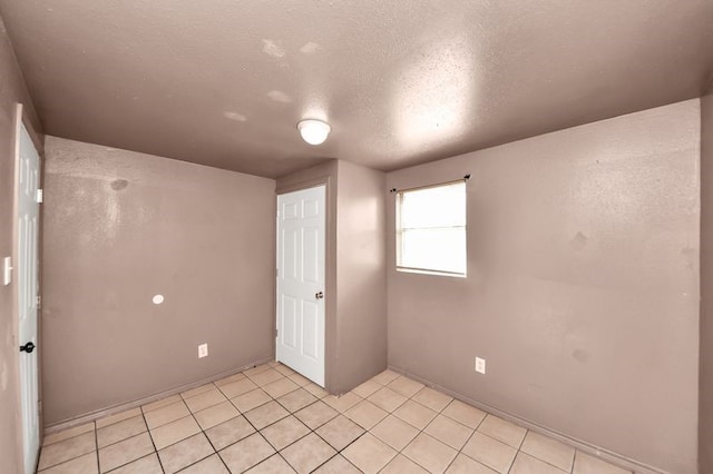 6821 Haight St, Houston, TX 77028 - unfurnished room with a textured ceiling and light tile patterned flooring