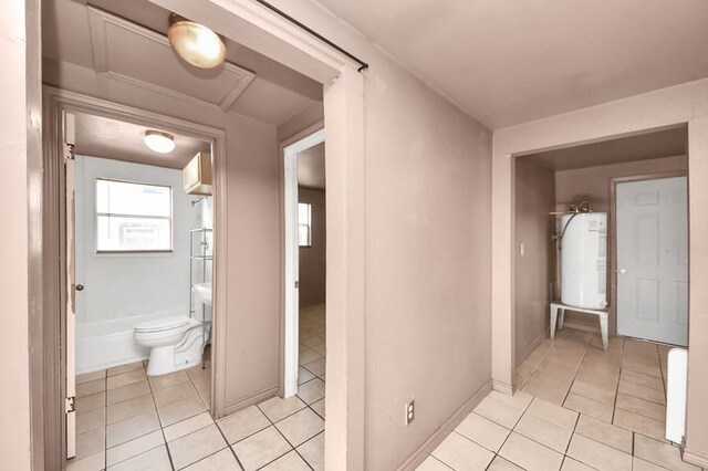 6821 Haight St, Houston, TX 77028 - bathroom featuring electric water heater and tile patterned floors