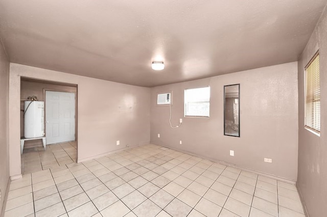 6821 Haight St, Houston, TX 77028 - empty room featuring light tile patterned floors and gas water heater