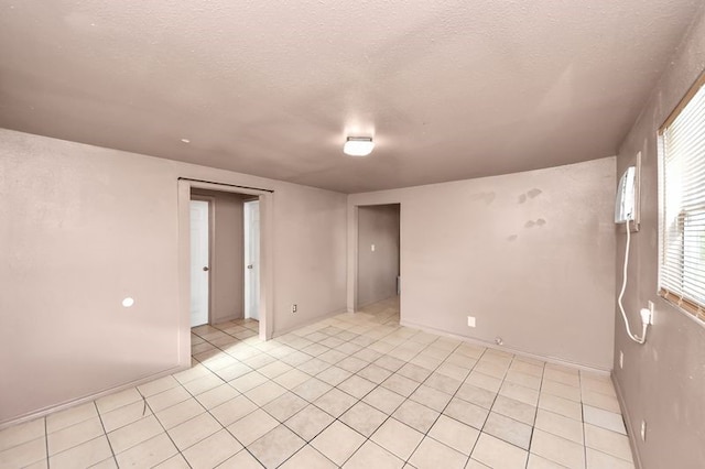 6821 Haight St, Houston, TX 77028 - spare room with light tile patterned floors and a textured ceiling