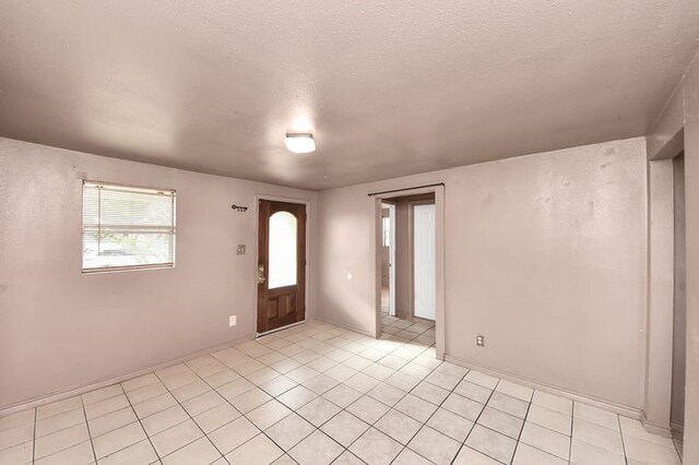 6821 Haight St, Houston, TX 77028 - entrance foyer with light tile patterned flooring and a textured ceiling