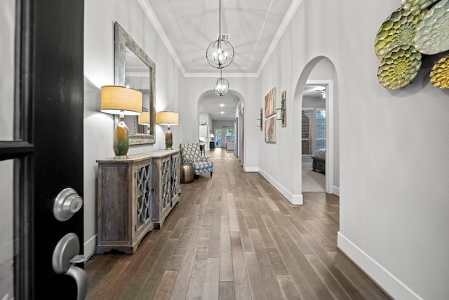 30 Madrone Terrace Pl, Tomball, TX 77375 - corridor with arched walkways, dark wood-type flooring, ornamental molding, and a chandelier