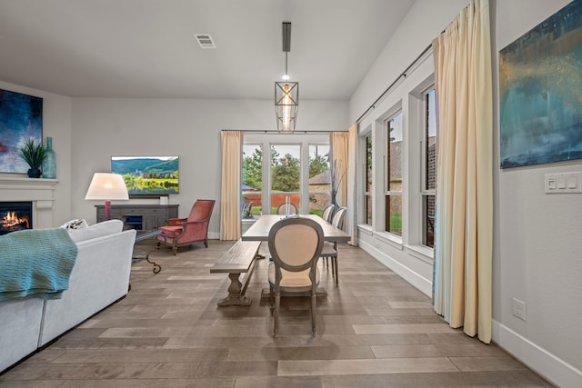 30 Madrone Terrace Pl, Tomball, TX 77375 - dining space with a warm lit fireplace and wood finished floors