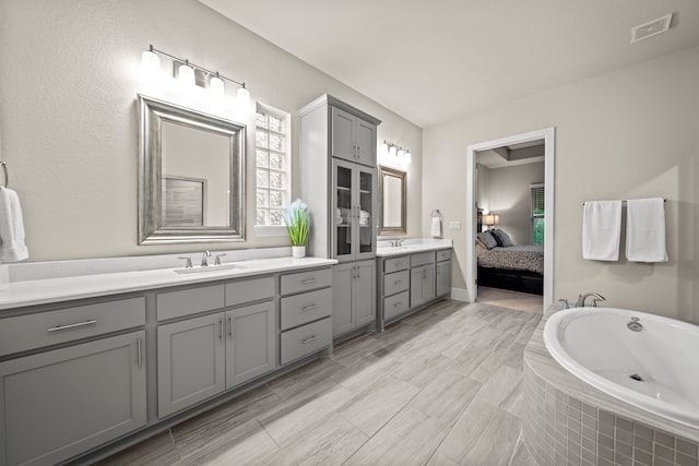 30 Madrone Terrace Pl, Tomball, TX 77375 - ensuite bathroom featuring vanity, plenty of natural light, and tiled tub
