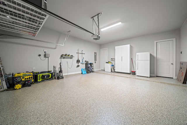 30 Madrone Terrace Pl, Tomball, TX 77375 - garage featuring freestanding refrigerator, a garage door opener, and electric panel