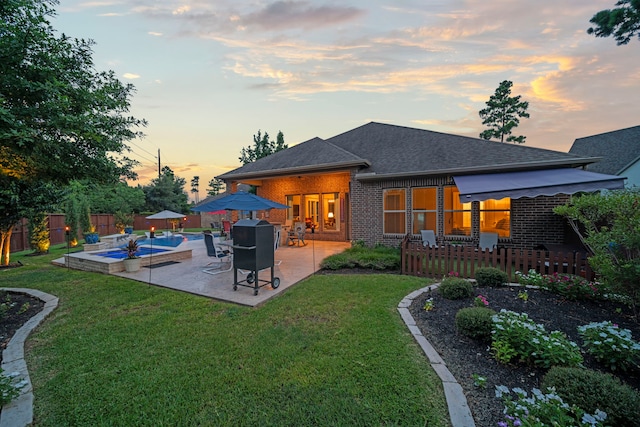 30 Madrone Terrace Pl, Tomball, TX 77375 - back of property with brick siding, a fenced backyard, roof with shingles, and a patio area