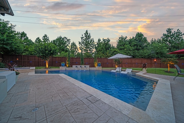 30 Madrone Terrace Pl, Tomball, TX 77375 - pool at dusk with a patio and a fenced backyard