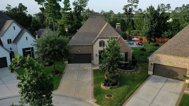 30 Madrone Terrace Pl, Tomball, TX 77375 - view of front of home featuring driveway, brick siding, a chimney, and a shingled roof