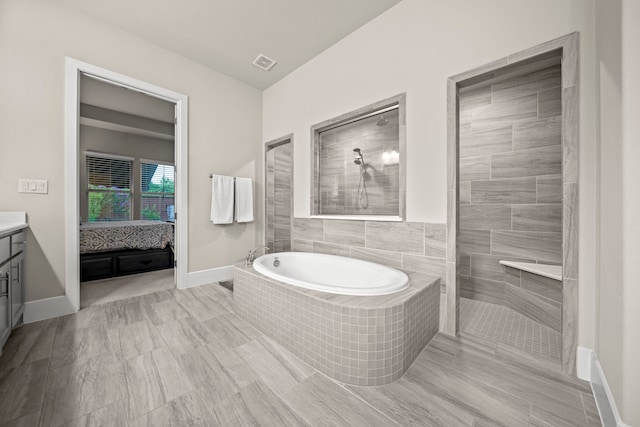 30 Madrone Terrace Pl, Tomball, TX 77375 - bathroom featuring vanity, a bath, and a walk in shower