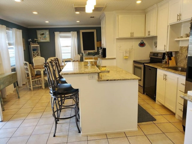 23002 Vida, Galveston, TX 77554 - kitchen featuring electric stove, recessed lighting, a kitchen island, white cabinetry, and light tile patterned floors