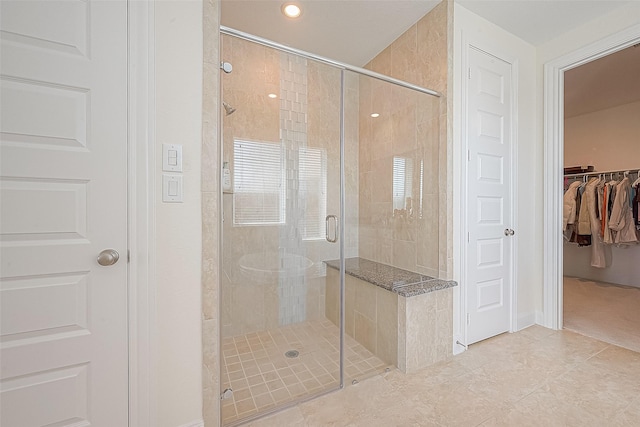 47 Monarch Trl, Sugar Land, TX 77498 - bathroom with a shower stall, a walk in closet, tile patterned floors, and recessed lighting
