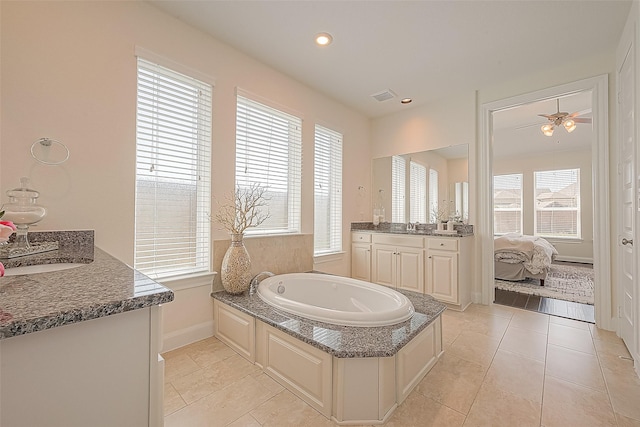 47 Monarch Trl, Sugar Land, TX 77498 - ensuite bathroom featuring two vanities, a bath, tile patterned flooring, and recessed lighting