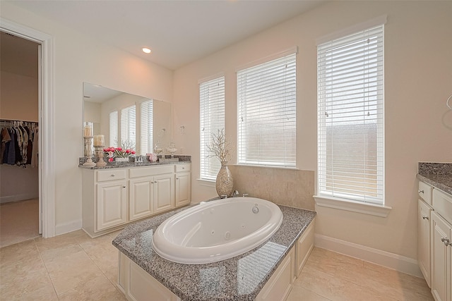 47 Monarch Trl, Sugar Land, TX 77498 - bathroom featuring vanity, a whirlpool tub, a spacious closet, and recessed lighting