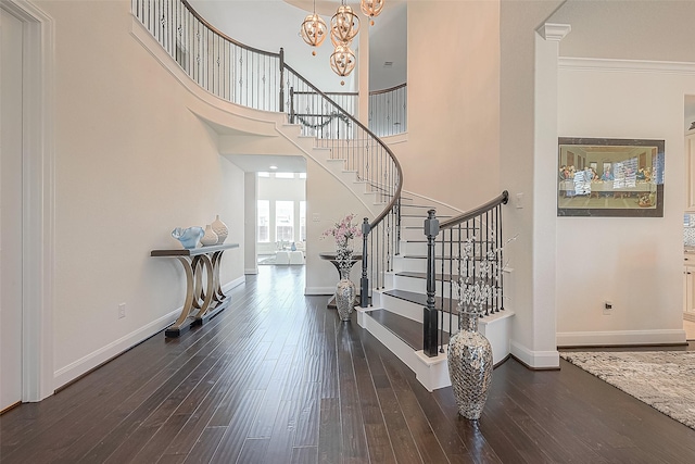 47 Monarch Trl, Sugar Land, TX 77498 - staircase with hardwood / wood-style flooring, a chandelier, ornamental molding, and a towering ceiling
