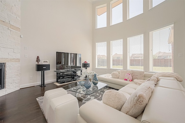 47 Monarch Trl, Sugar Land, TX 77498 - living area featuring dark wood-type flooring, a towering ceiling, and a fireplace