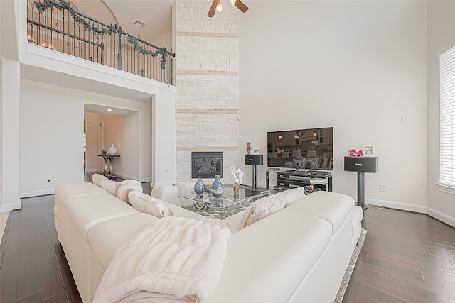 47 Monarch Trl, Sugar Land, TX 77498 - living room featuring ceiling fan, a high ceiling, wood finished floors, and a fireplace