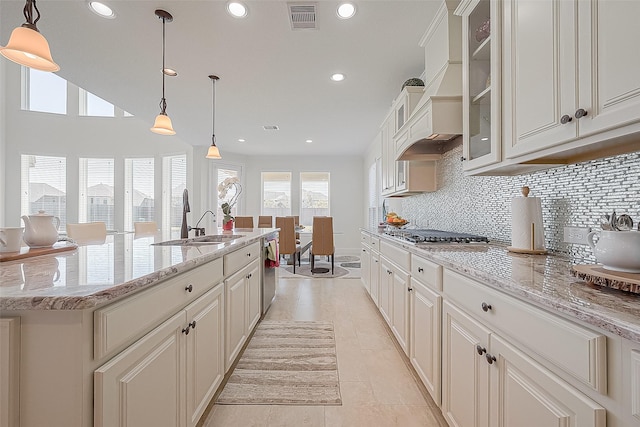 47 Monarch Trl, Sugar Land, TX 77498 - kitchen featuring decorative backsplash, recessed lighting, glass insert cabinets, light stone counters, and appliances with stainless steel finishes