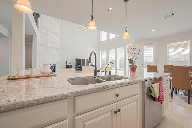 47 Monarch Trl, Sugar Land, TX 77498 - kitchen featuring dishwasher, hanging light fixtures, light tile patterned floors, light stone counters, and recessed lighting