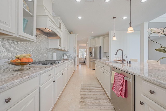 47 Monarch Trl, Sugar Land, TX 77498 - kitchen featuring stainless steel appliances, decorative backsplash, white cabinets, premium range hood, and recessed lighting