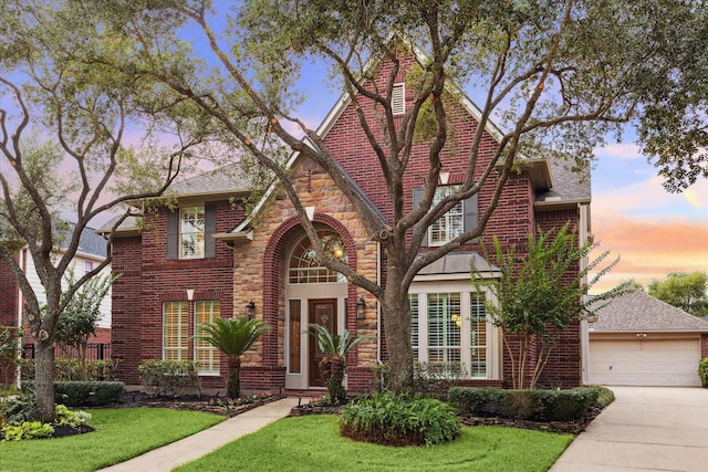 12410 Sonata Canyon Ln, Houston, TX 77041 - tudor-style house featuring a front yard, a garage, driveway, and brick siding