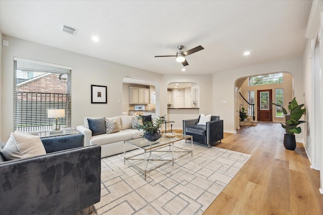 12410 Sonata Canyon Ln, Houston, TX 77041 - living room with arched walkways, light wood-type flooring, ceiling fan, and recessed lighting