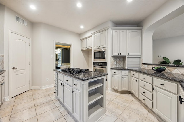 12410 Sonata Canyon Ln, Houston, TX 77041 - kitchen featuring light marble finish floors, dark stone countertops, recessed lighting, stainless steel oven, and gas cooktop