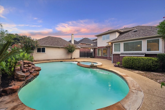 12410 Sonata Canyon Ln, Houston, TX 77041 - pool at dusk with a pool with connected hot tub and a patio