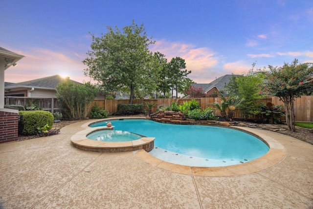 12410 Sonata Canyon Ln, Houston, TX 77041 - pool at dusk with a pool with connected hot tub, a fenced backyard, and a patio