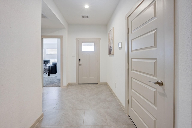 29918 Reagans Ranch Dr, Katy, TX 77494 - doorway featuring light tile patterned floors, light carpet, and recessed lighting