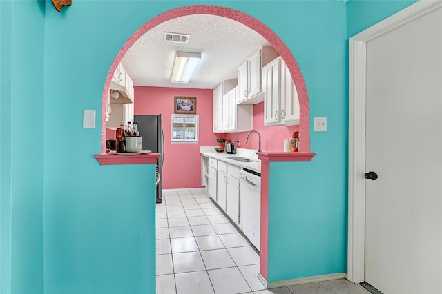 15811 Beechnut St, Houston, TX 77083 - kitchen with white dishwasher, a textured ceiling, white cabinetry, and arched walkways