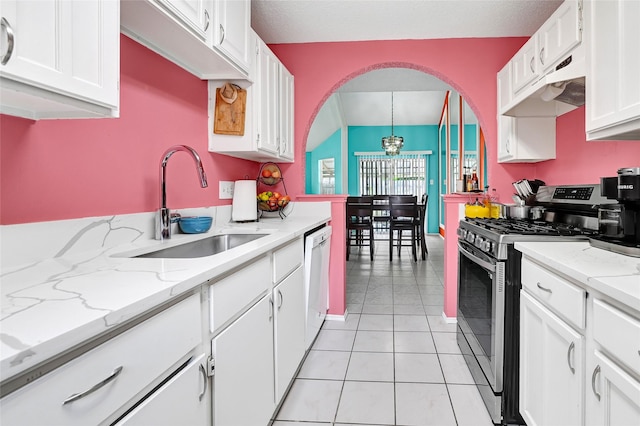 15811 Beechnut St, Houston, TX 77083 - kitchen featuring stainless steel gas range oven, under cabinet range hood, white cabinetry, arched walkways, and light tile patterned floors
