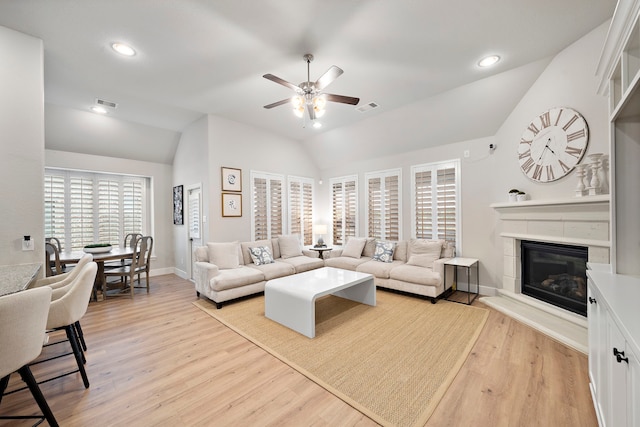 2707 Wollemi Pine Trl, Katy, TX 77493 - living room featuring vaulted ceiling, a ceiling fan, a glass covered fireplace, light wood finished floors, and recessed lighting