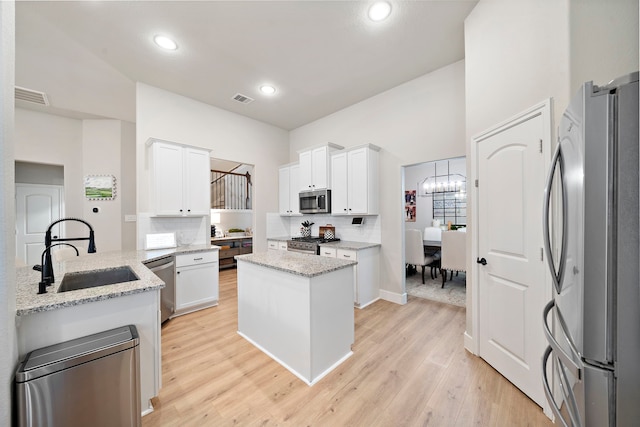 2707 Wollemi Pine Trl, Katy, TX 77493 - kitchen with appliances with stainless steel finishes, light wood-style floors, decorative backsplash, white cabinets, and recessed lighting