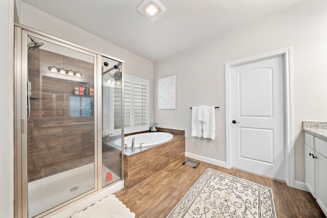 2707 Wollemi Pine Trl, Katy, TX 77493 - full bathroom featuring vanity, a garden tub, a shower stall, and wood finished floors